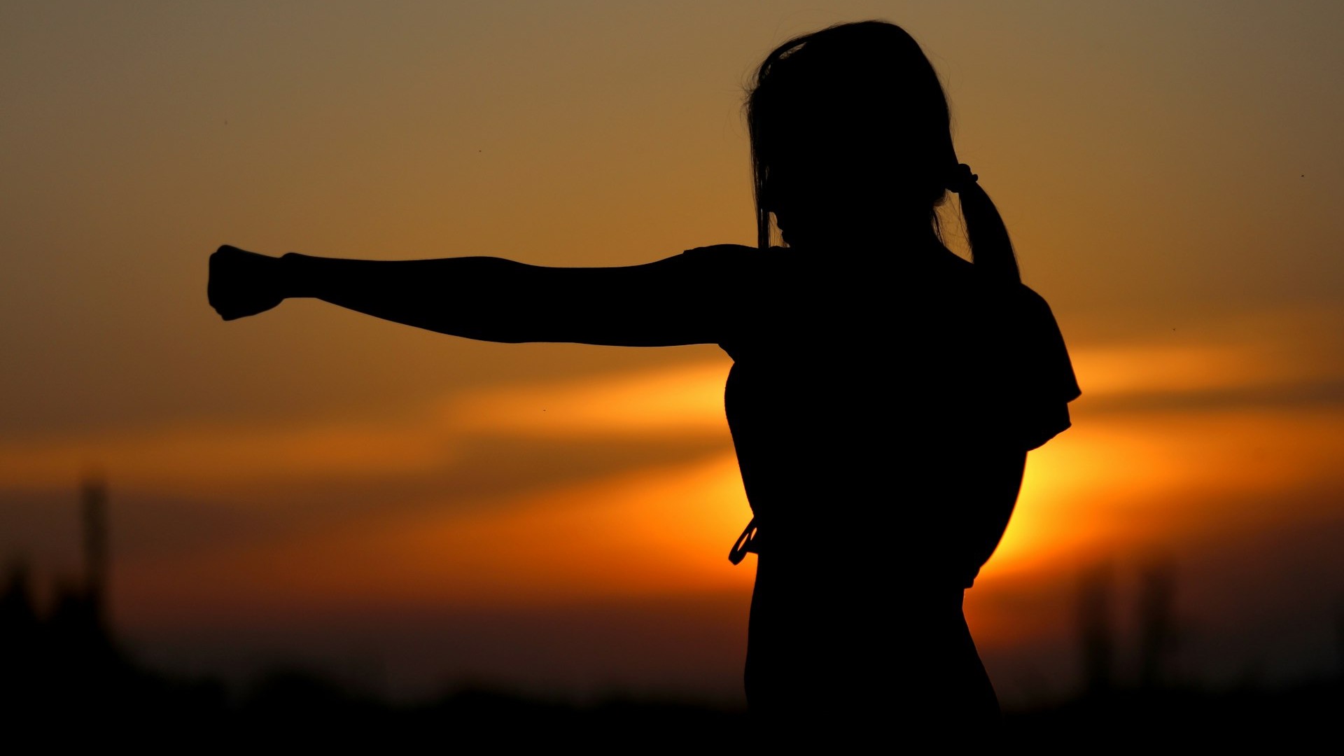 woman punching the air during golden hour